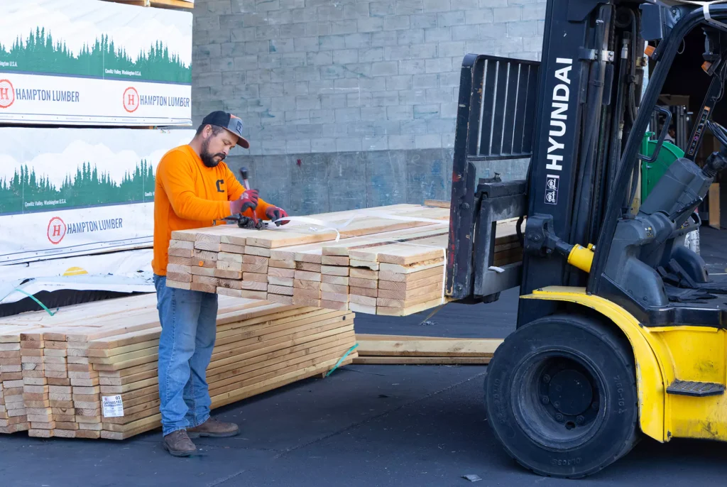Colonial yard worker loading framing lumber with a forklift in Centerville, Utah
