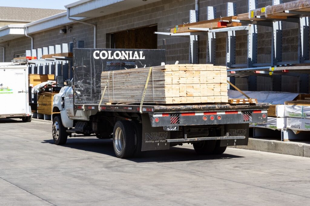 Colonial lumber delivery truck loading materials in Northern Utah