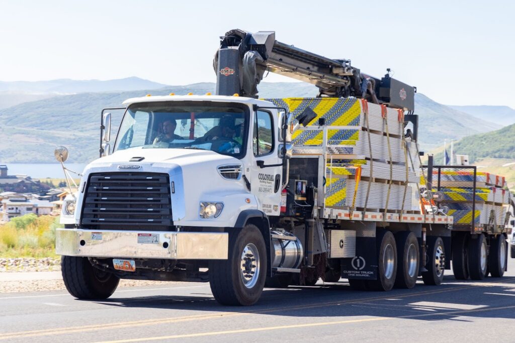 Drywall delivery truck hauling materials across Northern Utah